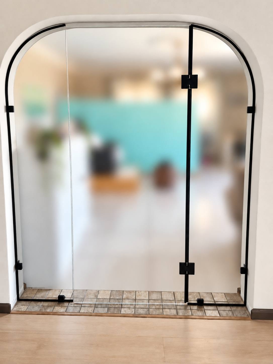 Arched black-framed glass door